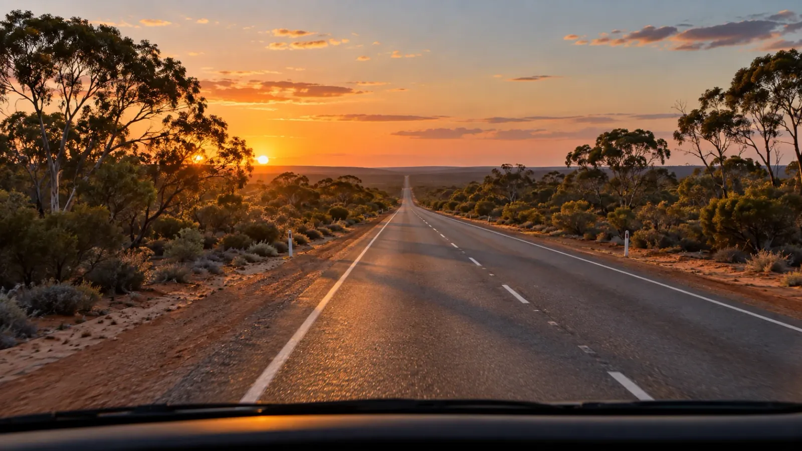 Illustrative view from a truck cab along a Western Australian highway towards a golden sunset
